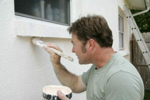Man painting exterior walls