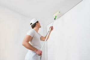 Man painting a ceiling